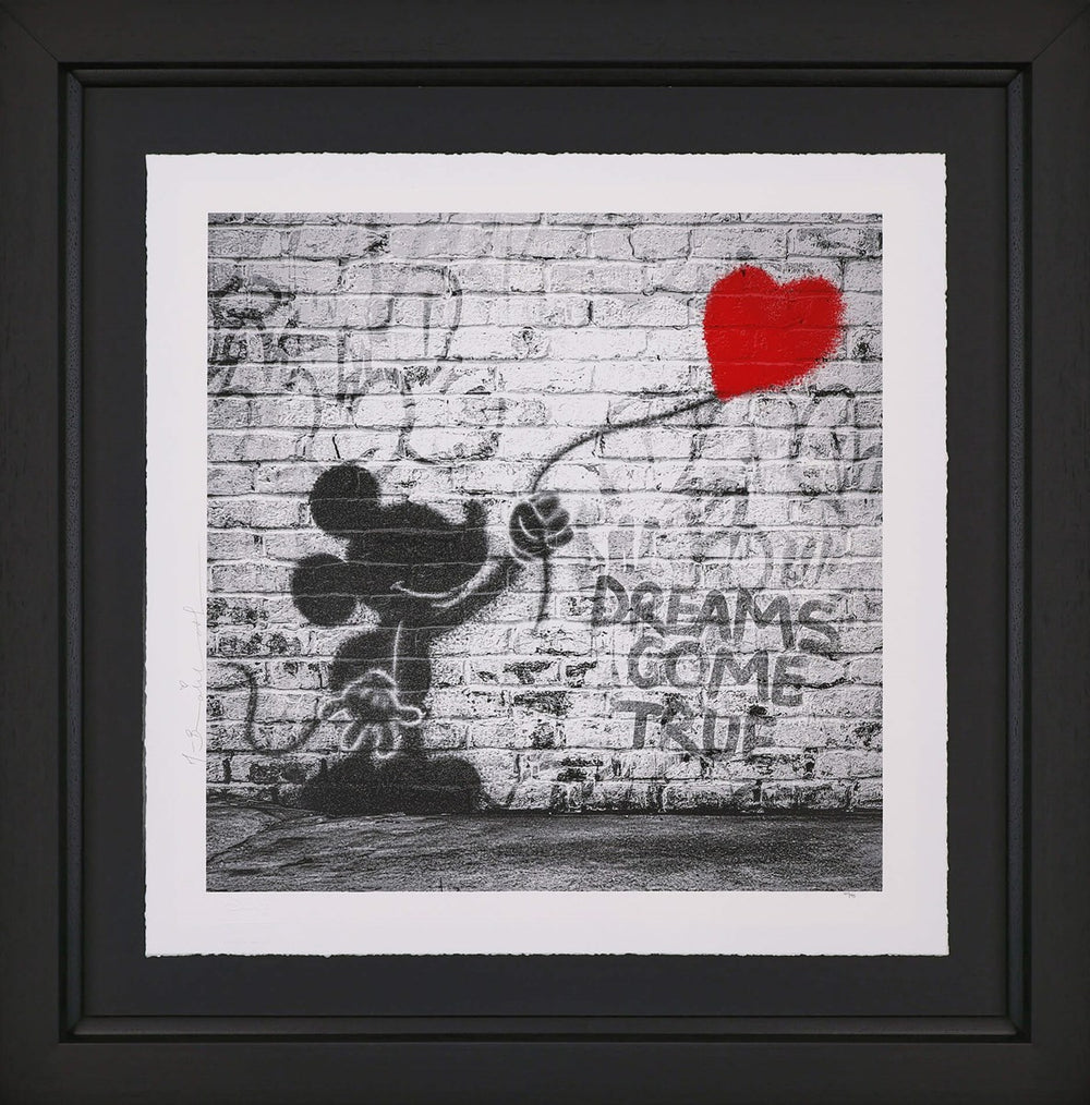 Black and white graffiti-style artwork by Mr. Brainwash depicting Mickey Mouse and a spray-painting of a red heart balloon on a brick wall. The phrase ‘DREAMS COME TRUE’ is stencilled beside him.