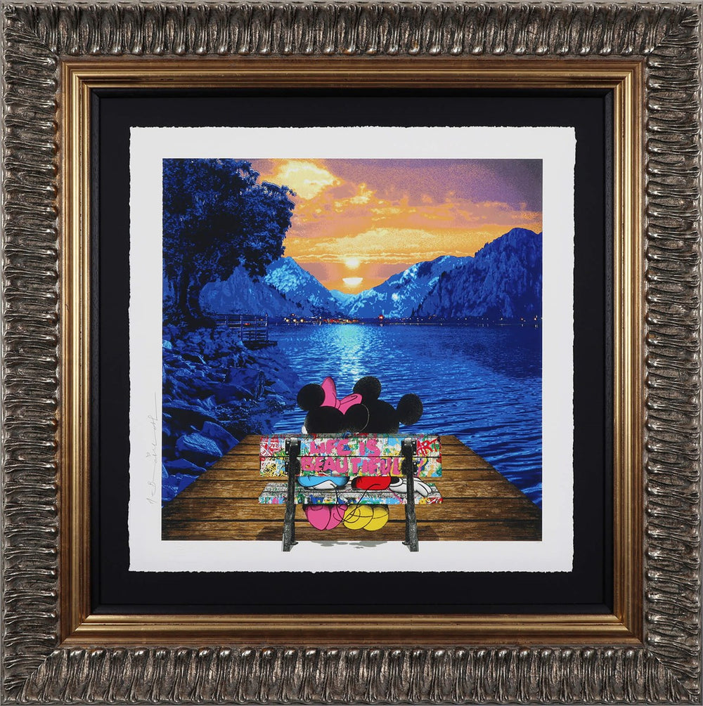 Mr Brainwash painting of Mickey and Minnie Mouse on a bench watching the sunset over a lake with mountains